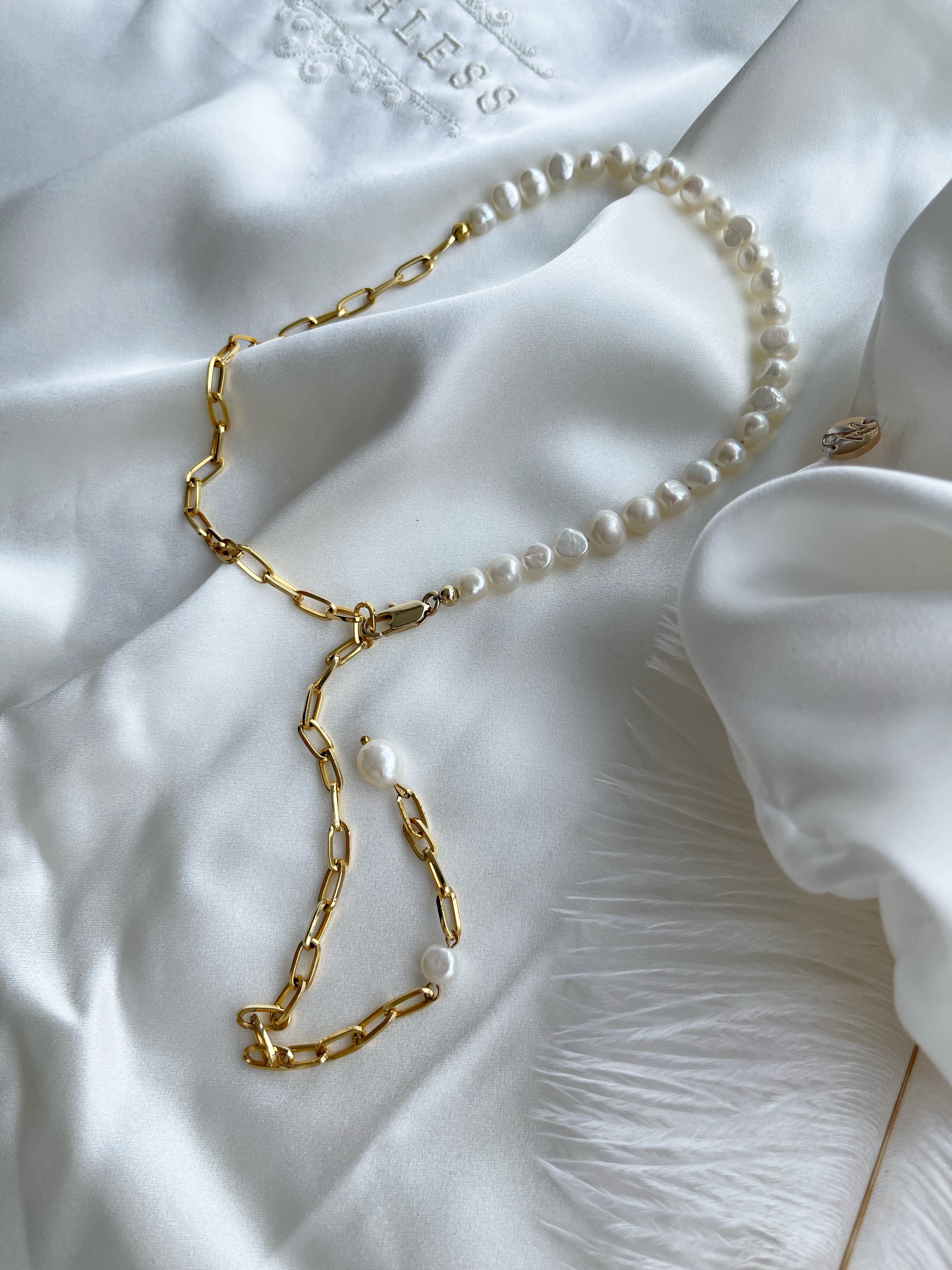 "Cultured Natural Pearl Necklace" by Shirley Navone with gold-plated metallic details.
